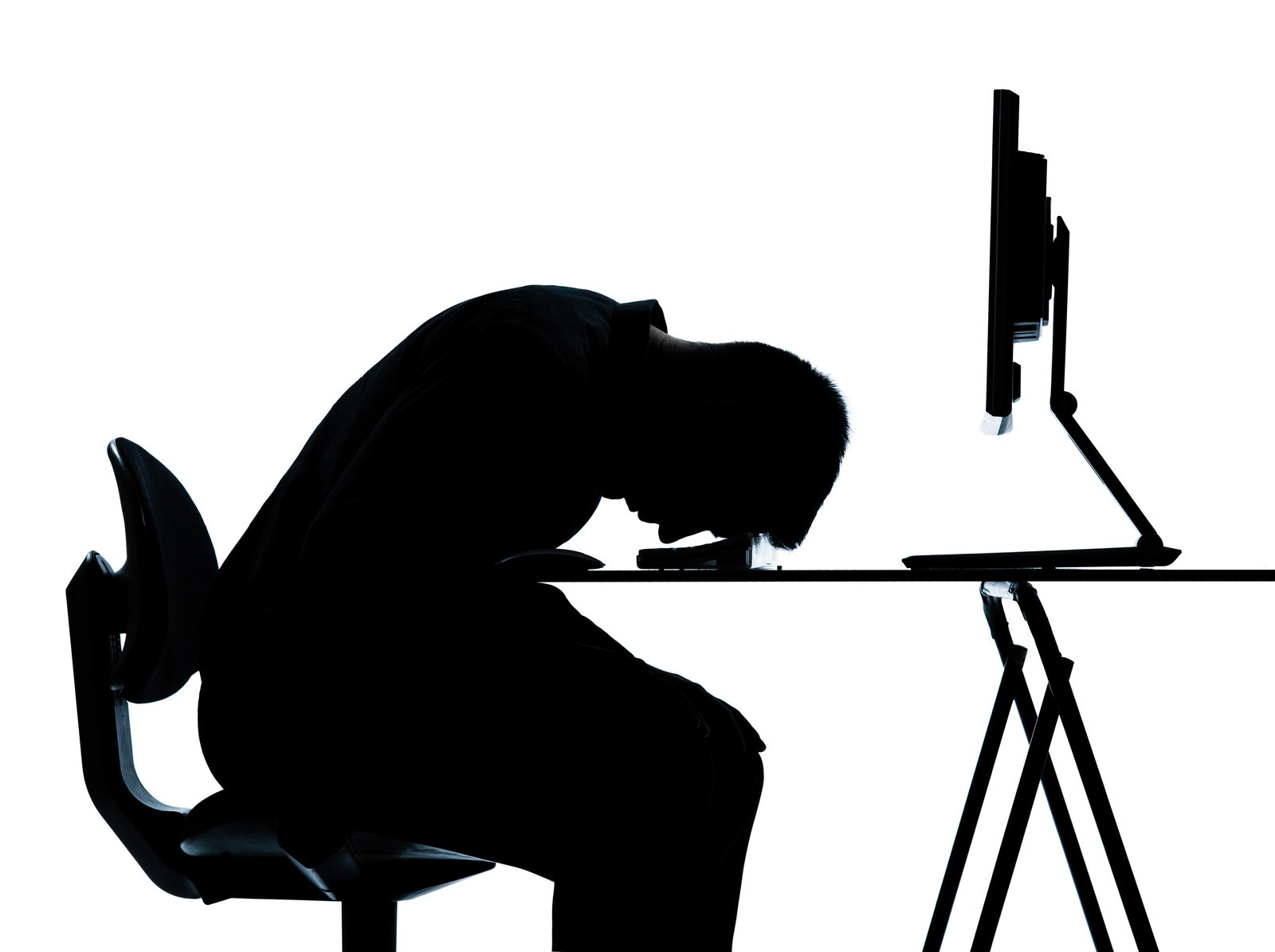 man sitting at computer, head on desk