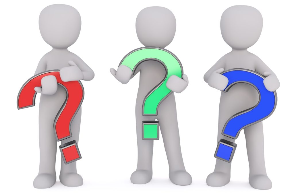 3 figures holding question marks