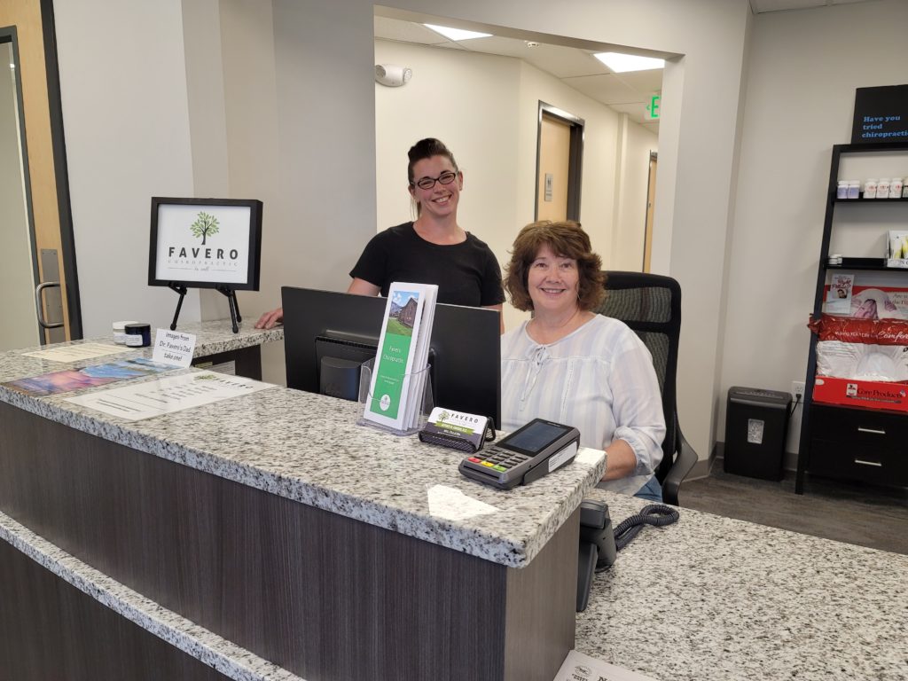 Jess & Sheila at front desk of chiropractic clinic